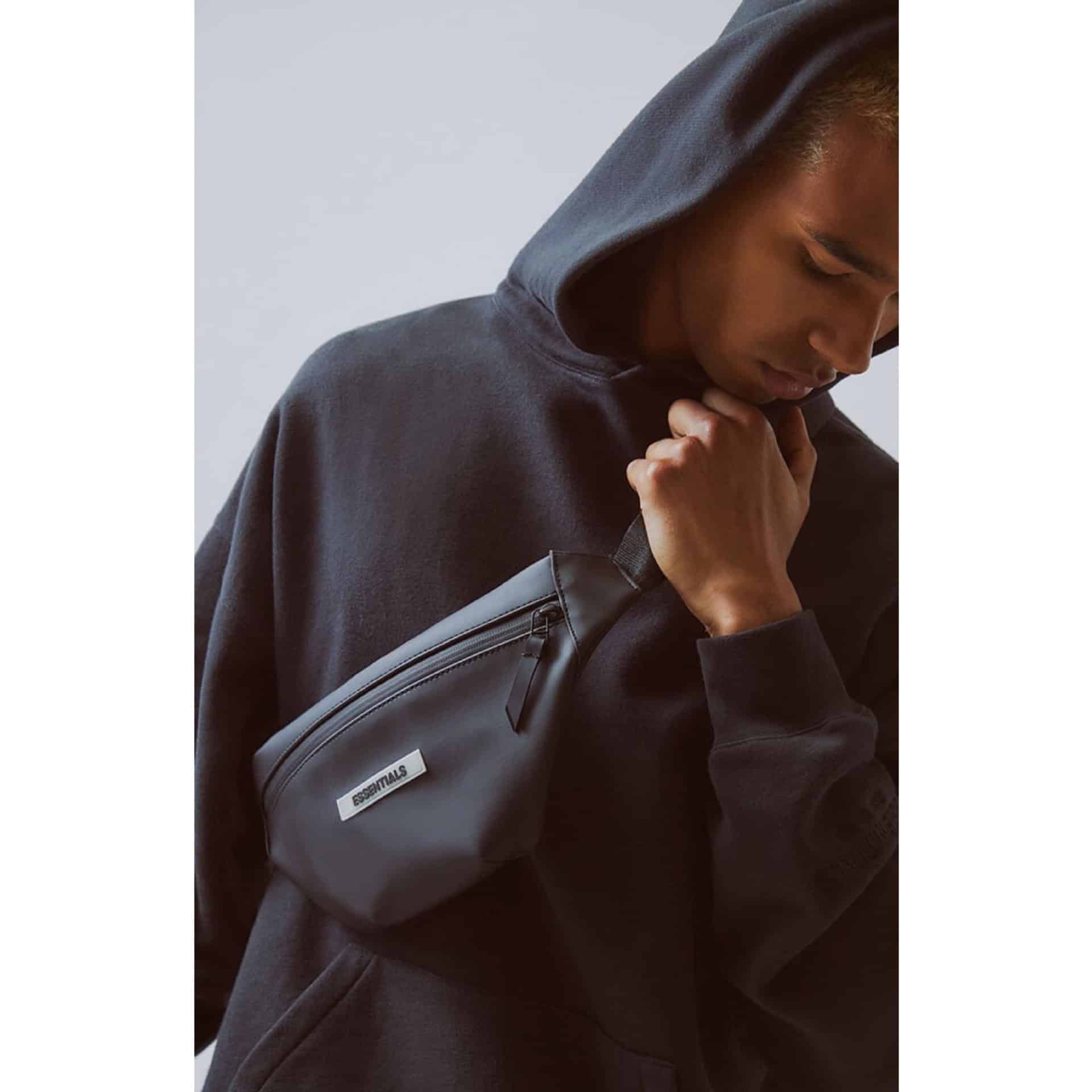 - Black hoodie with a small black crossbody bag for streetwear and casual fashion.