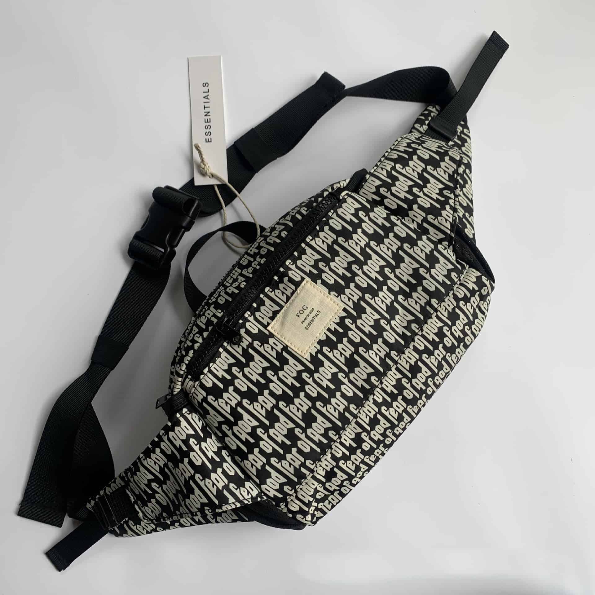 Black and white patterned K-pop merchandise bag with multiple compartments and adjustable straps.