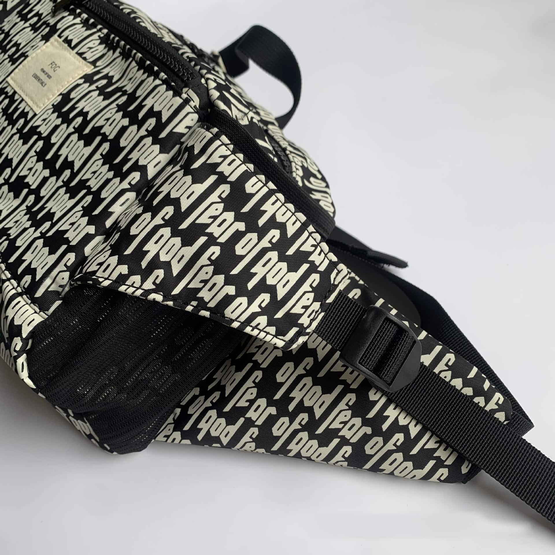 Backpack with repeated "POD" text pattern, black and white vinyl accessories, dual compartments, adjustable straps, trendy K-pop merchandise.