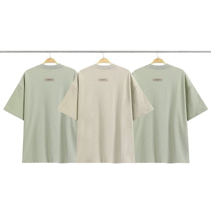 Eco-friendly K-pop merchandise t-shirts in pastel shades featuring minimalist design and brand logo, perfect for fans.