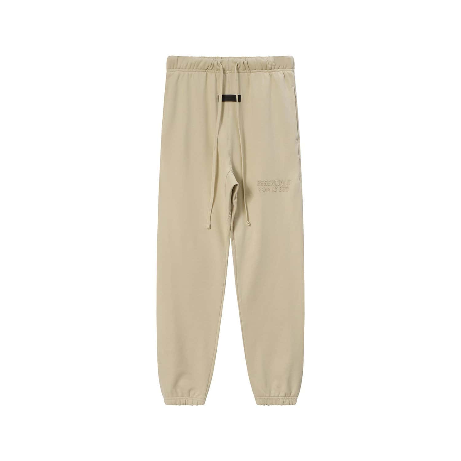 Soft beige jogger pants with elastic waistband and drawstring, featuring subtle embossed text detail. Perfect for casual K-pop merchandise collections and streetwear outfits.