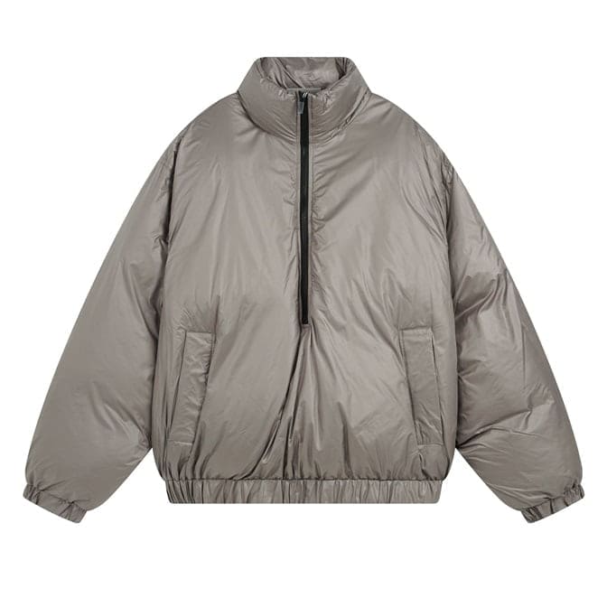 Oversized beige puffer jacket with front zipper and elastic cuffs, perfect for casual lifestyles and streetwear fashion. Versatile and cozy for colder weather.
