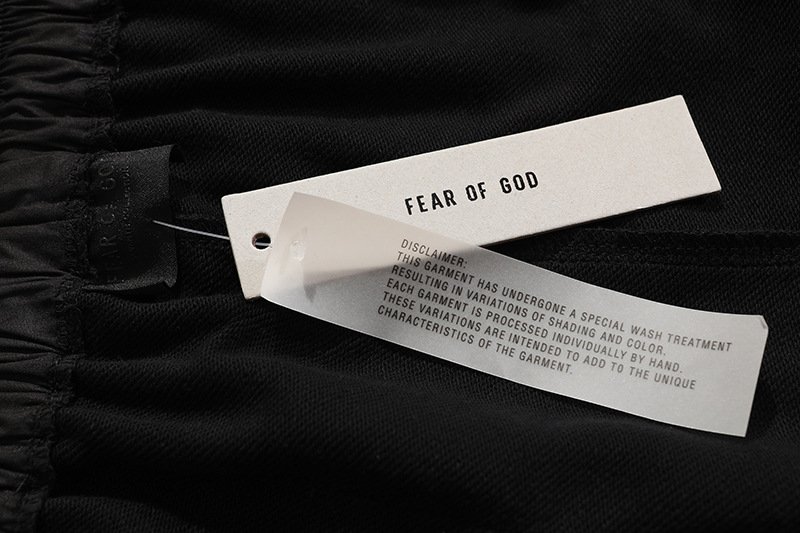 Fear of God black clothing tag with white label and detailed care instructions.