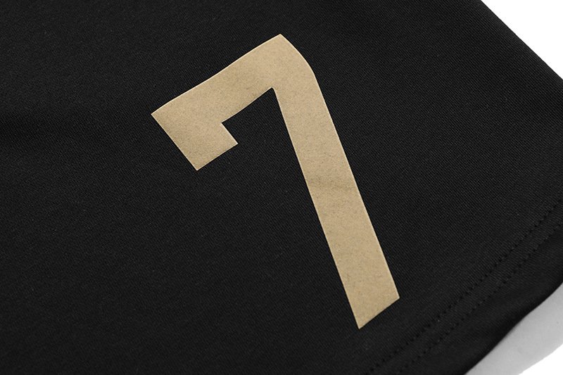 Black kpop merch with a large beige number 7 printed on fabric.