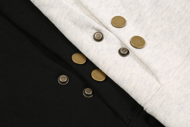 Gold and silver snap button jewelry-inspired fashion accessories on layered fabric background.
