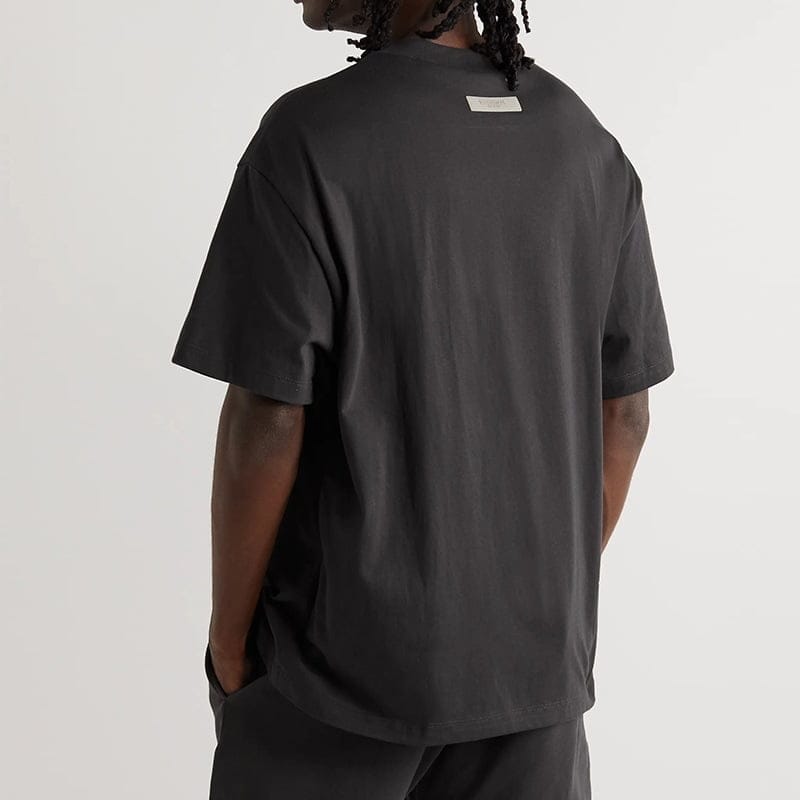 Black oversized t-shirt with a small white tag on the back neckline, casual streetwear style for K-pop merch fans.