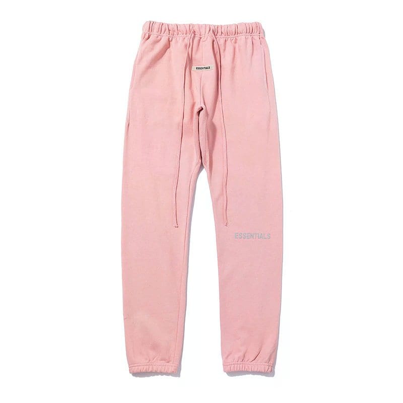 Pink pastel joggers with "ESSENTIALS" logo, comfortable casual streetwear for everyday wear designed for K-pop fashion fans.