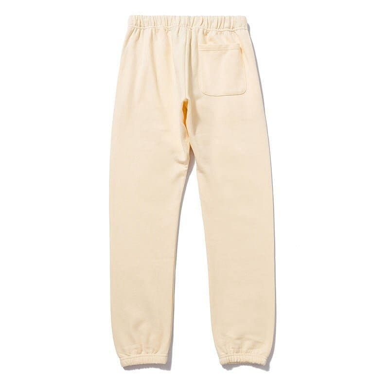 Sweatpants with elastic waistband and cuffed ankles in beige color.