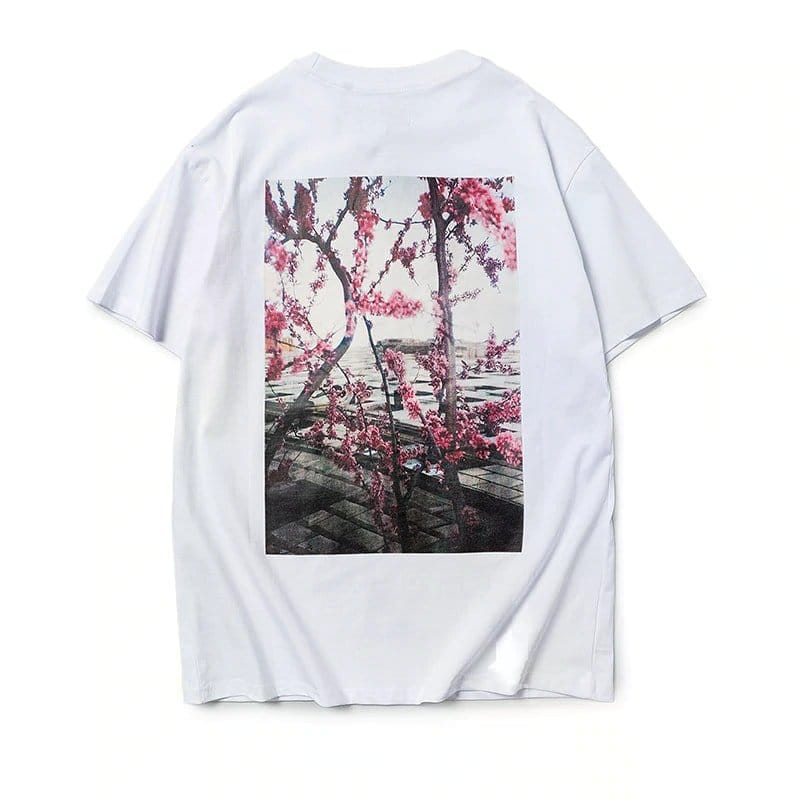 Pink blossom tree graphic t-shirt with scenic background, trendy K-pop merch for fans of Korean pop culture.