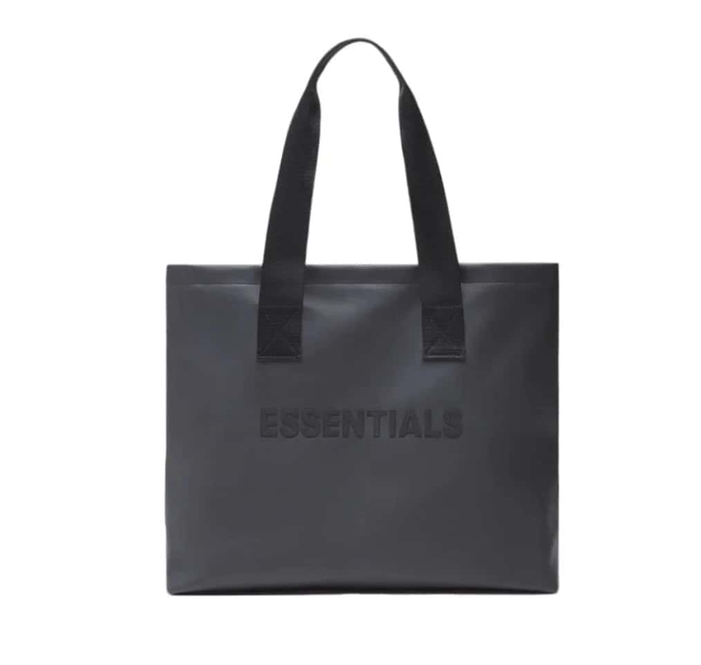 Black tote bag with "ESSENTIALS" embossed text, minimalistic design, online store merchandise.