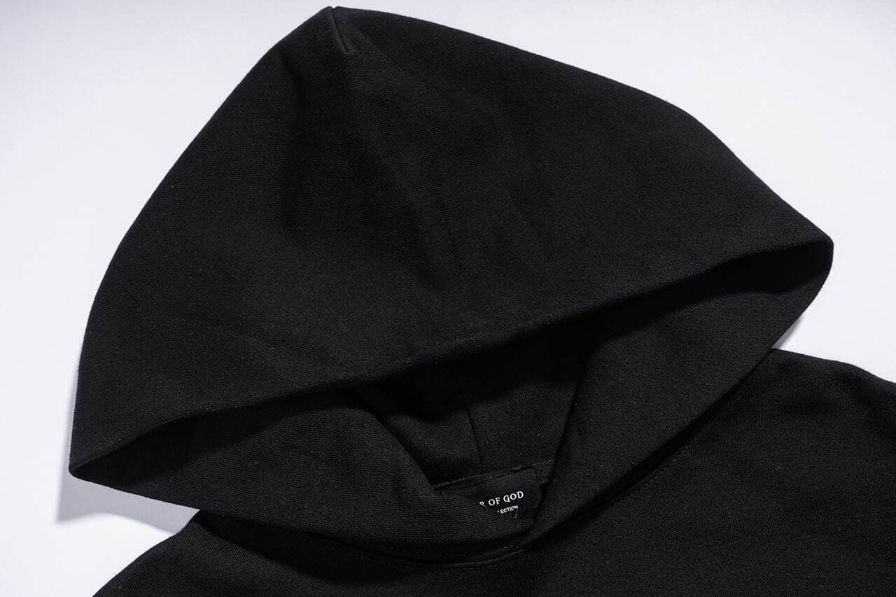 Black hoodie with hood up for K-pop merchandise collection.