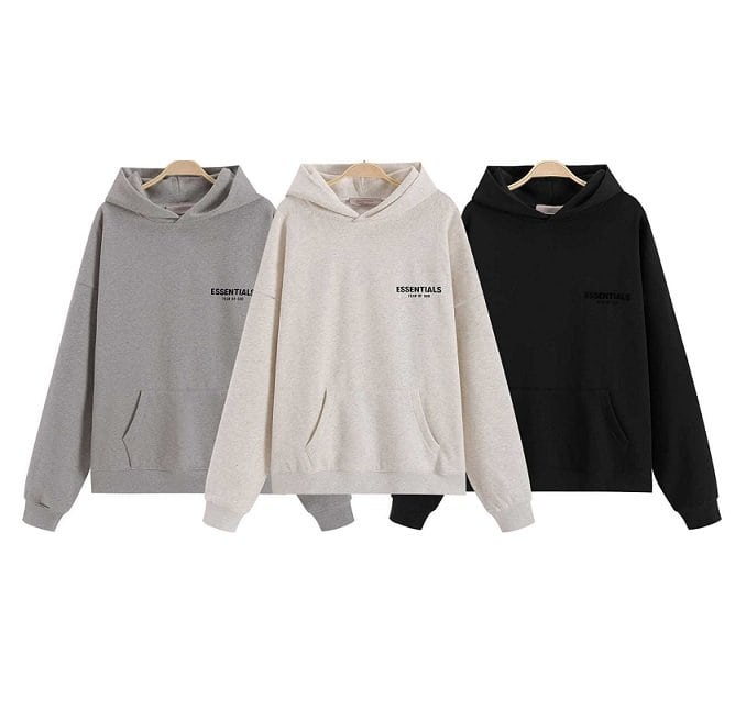 Soft grey, white, and black hoodies featuring minimal "ESSENTIALS" branding, perfect for K-pop merch fans or casual wear. These stylish, comfortable hoodies are ideal for showcasing K-pop fandom and fashion.