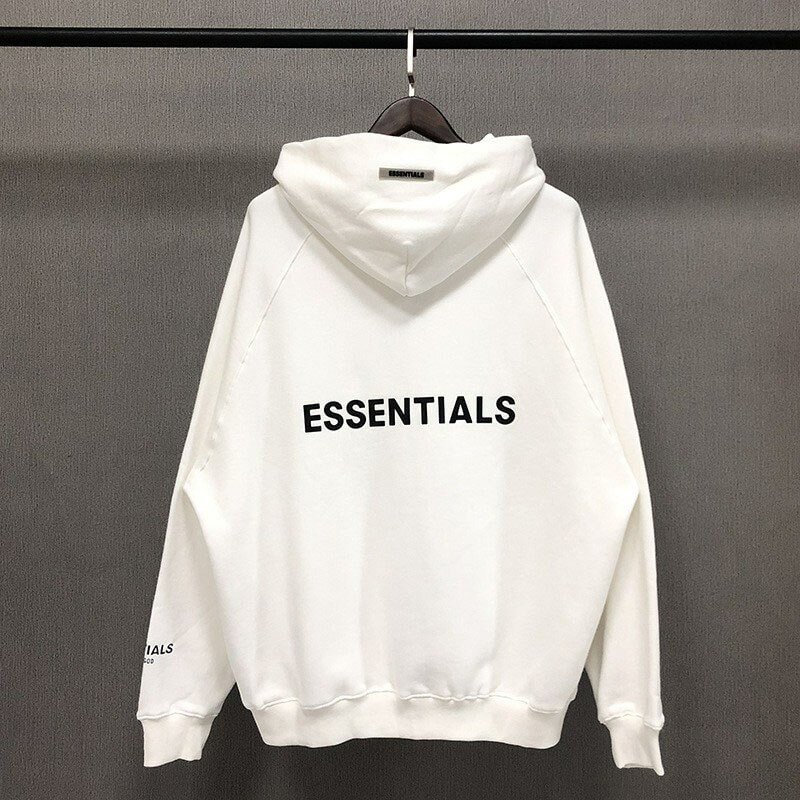 White hoodie with "ESSENTIALS" text in black across the chest, featuring a relaxed fit and soft fabric, perfect for casual K-pop fanwear and merchandise collections.