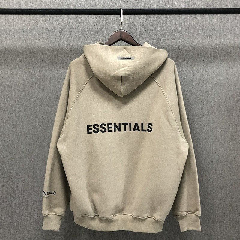 Essential hoodie with "ESSENTIALS" printed on back, neutral color, casual streetwear style, popular among K-pop fans and merch collectors.