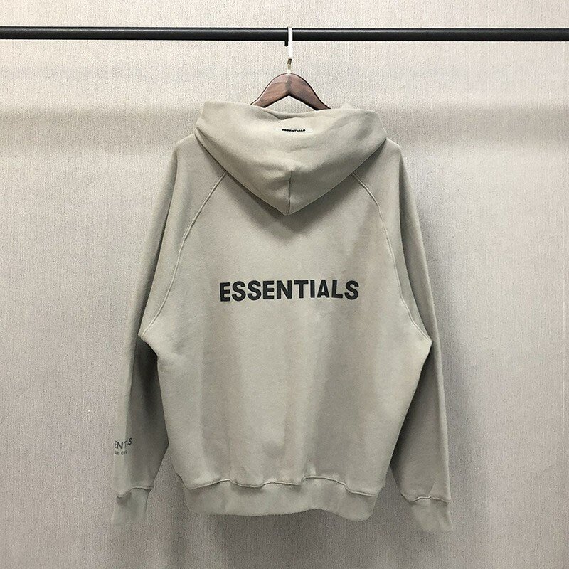 Wearable TWICE K-pop merchandise hoodie featuring the word ESSENTIALS printed on the back, beige color, casual style for fans who love K-pop fashion and accessories.