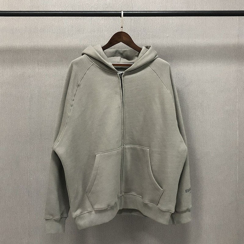 Hoodie clothing item, plain grey zip-up hoodie with pockets, displayed on a wooden hanger against a neutral background.