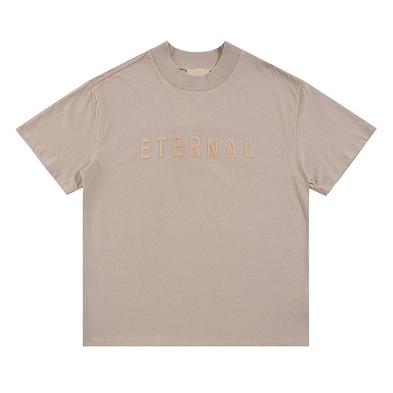 ETERNAL beige K-pop merch t-shirt with bold embroidered lettering, perfect for fans of K-pop music and fashion. Stylish and comfortable casual wear for K-pop enthusiasts.