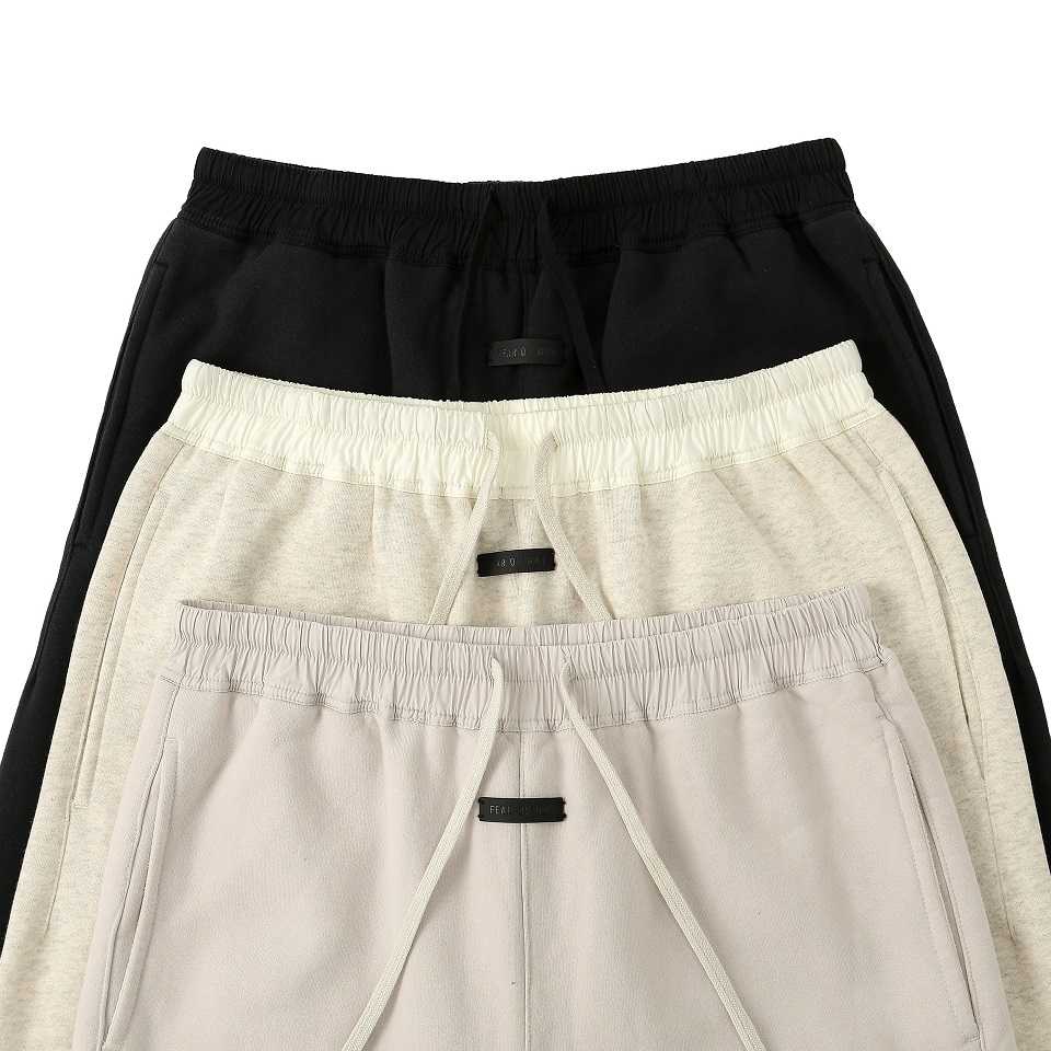 Black and beige sweatpants with drawstrings, casual loungewear, ideal for everyday comfort.