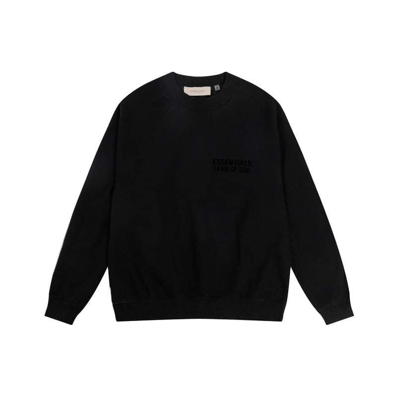 Black crewneck sweatshirt with "ESSENTIALS FEAR OF GOD" text, minimalist kpop merchandise piece for fans.