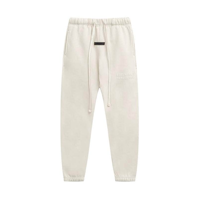 Relaxed fit cream jogger pants with embroidered text detail and adjustable drawstring waist. Comfortable loungewear perfect for casual outfits.