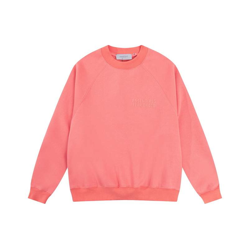 Crewneck sweatshirt in soft pink with minimal "ESSENTIALS FEAR OF GOD" text embossed on the front, casual and stylish, perfect for streetwear and K-pop fan ensembles.