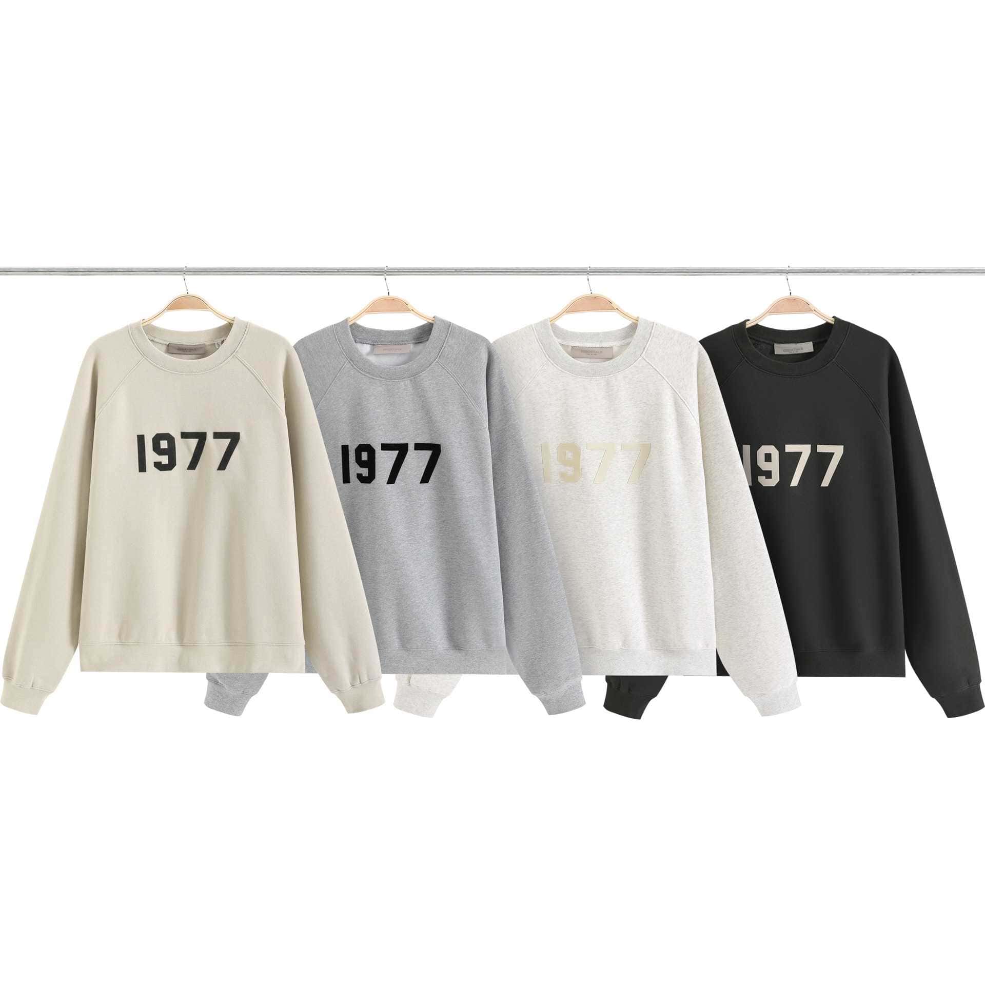 1977 K-pop merchandise sweatshirts in cream, gray, white, and black featuring bold "1977" text, perfect for K-pop fans. Stylish, comfortable apparel for celebrating K-pop culture and fandom.