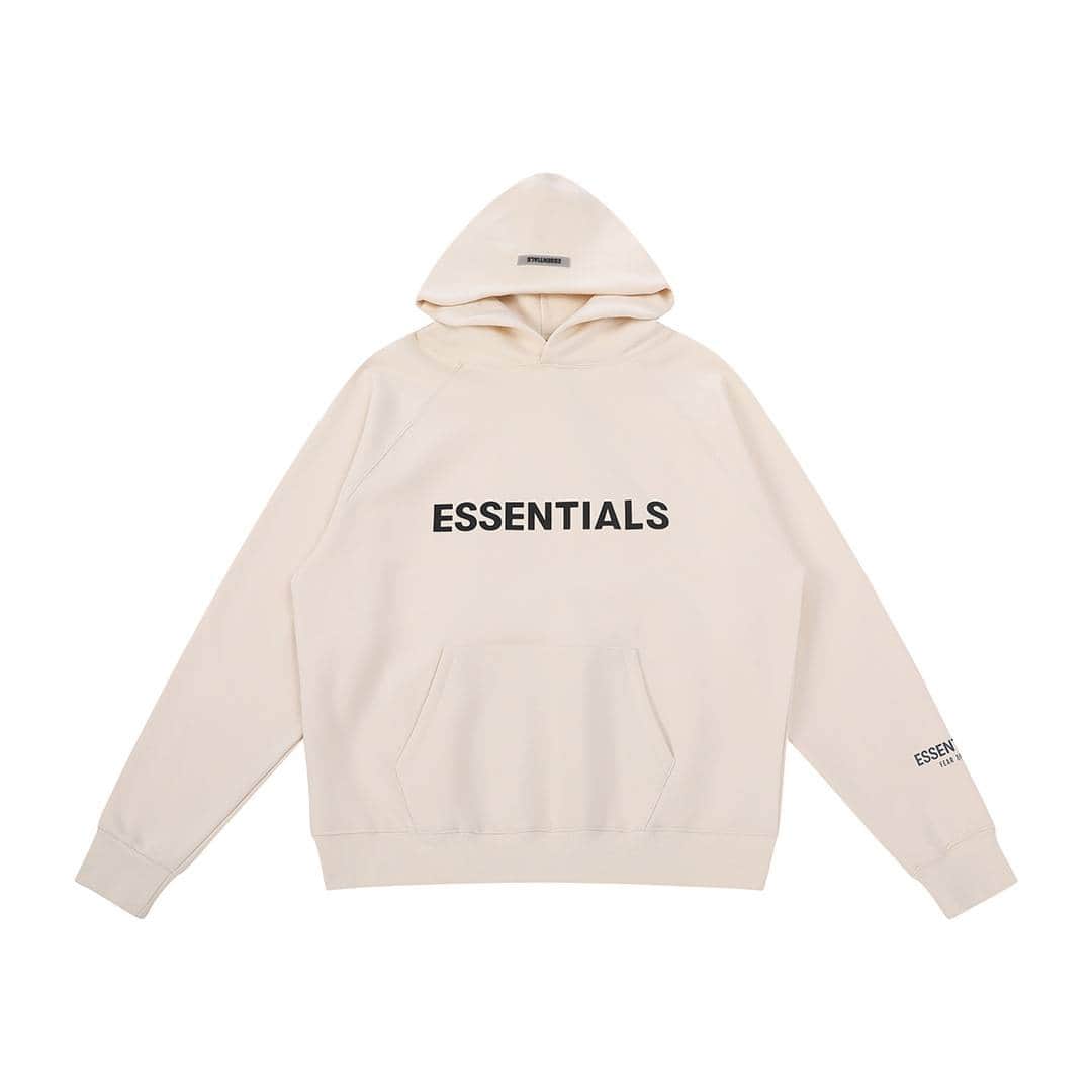 ESSENTIALS oversized hoodie in cream color with black text, perfect for casual K-pop fan style.