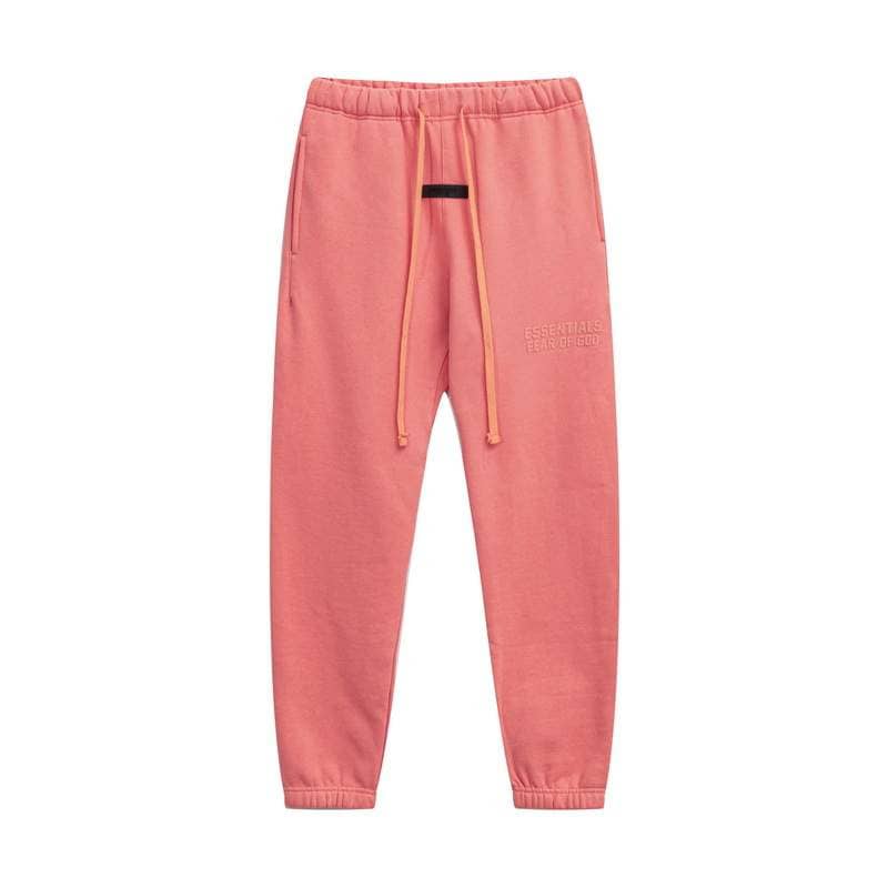 Oversized pink sweatpants with drawstring waist, casual loungewear, and embroidered text detail.