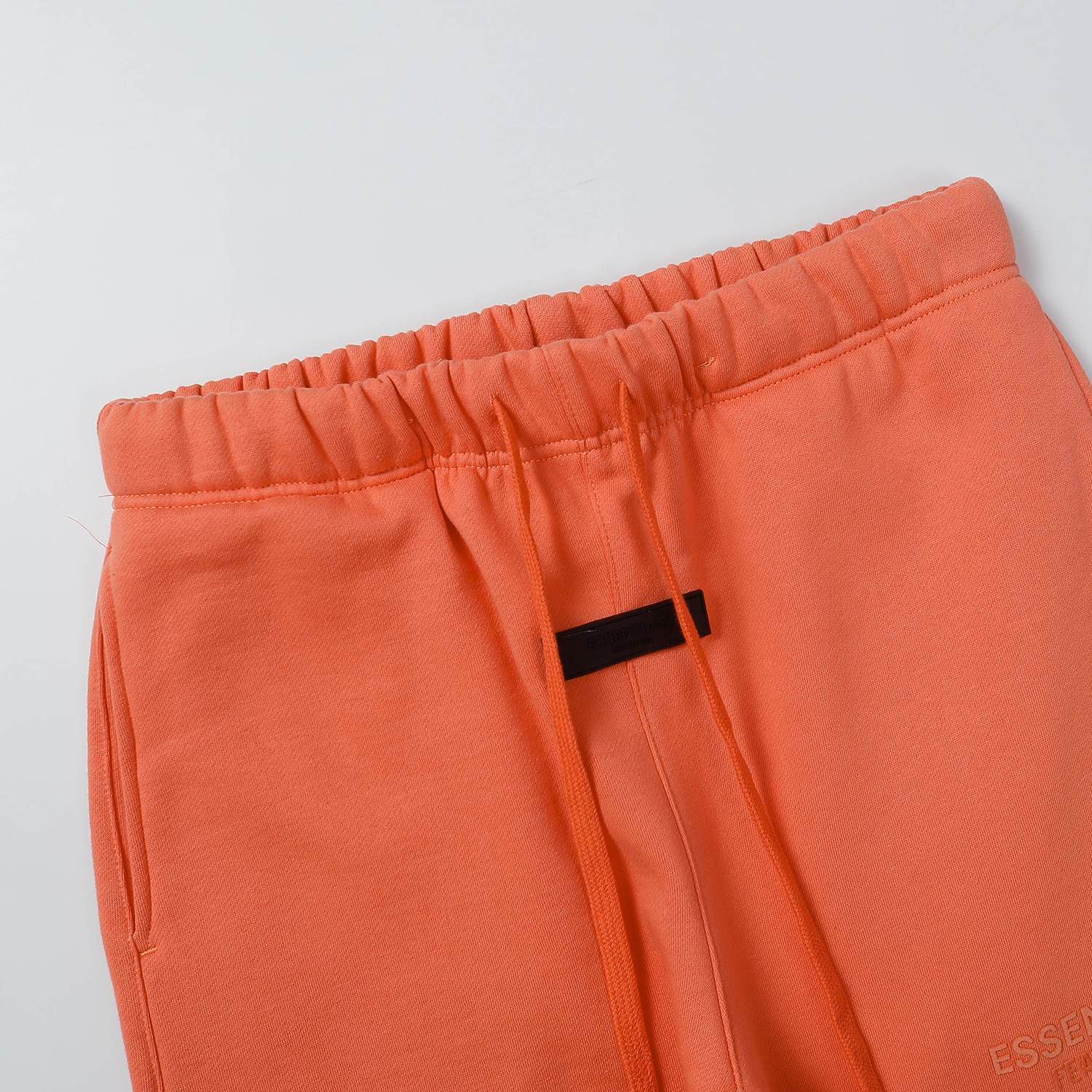 Bright orange K-pop themed sweatpants with elastic waistband and drawstring, perfect for fans of K-pop idols and merchandise. Stylish, comfortable, and ideal for casual wear or concerts.