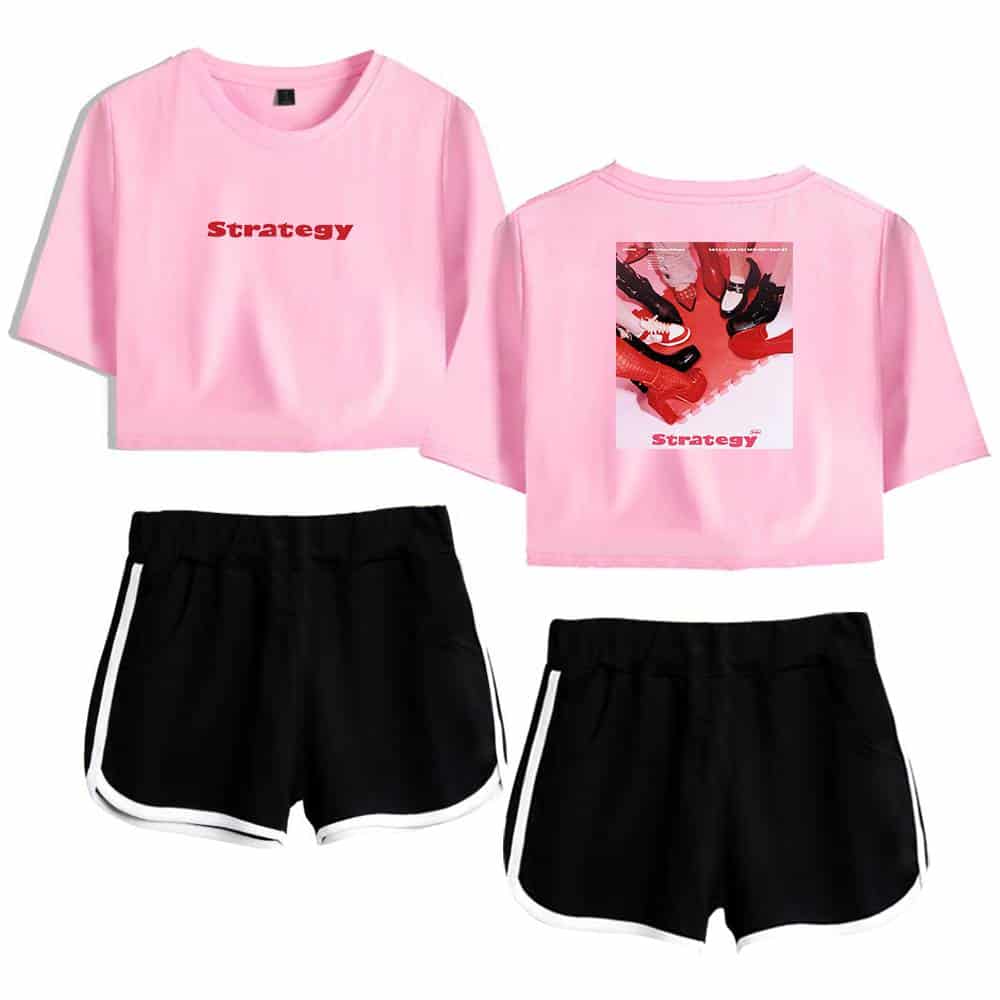 Pink cropped T-shirt with "strategy" text and a graphic of shoes on back, paired with black athletic shorts with white trim, trendy K-pop merchandise for fans.